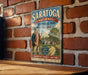 A vintage-style metal sign for Saratoga National Historical Park in New York, featuring an illustration of a soldier and a historical building.