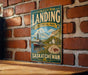 A vintage-style metal sign for Saskatchewan Landing, a scenic location in the Canadian province of Saskatchewan.