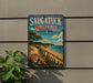 A vintage metal sign for Saugatuck Dunes State Park in Michigan, featuring a scenic beach landscape with a cliff and trees.