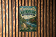 A vintage-style metal sign for Schuykill River Greenways, a National Heritage Area in Pennsylvania, is displayed on a wooden wall.
