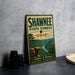 A vintage-style metal sign for Shawnee State Forest, Ohio, featuring a scenic landscape with a river and mountains.