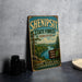 A vintage-style sign for the Shenipit State Forest in Connecticut, featuring a scenic landscape with pine trees, a river, and mountains.