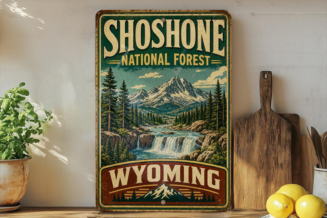 A vintage-style sign for Shoshone National Forest in Wyoming, featuring a scenic mountain landscape with a waterfall.