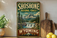 A vintage-style sign for Shoshone National Forest in Wyoming, featuring a scenic mountain landscape with a waterfall.
