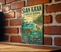 A vintage-style metal sign for the Sian Ka'an Biosphere Reserve in Mexico, featuring a tropical beach scene with a turtle, palm tree, and other wildlife.