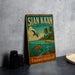 A vintage metal sign with a tropical beach scene and a bird in flight, advertising "SIAN KÁAN MEXICO" and "NATURAL HERITAGE PARADISE PRESERVED".