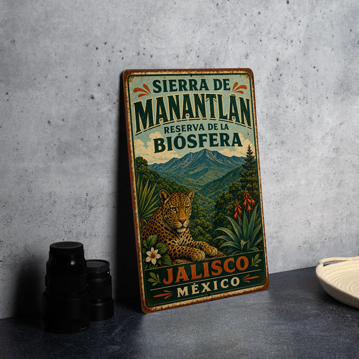 A vintage-style metal sign with a leopard and tropical foliage, advertising the Sierra de Manantlan reserve in Mexico.