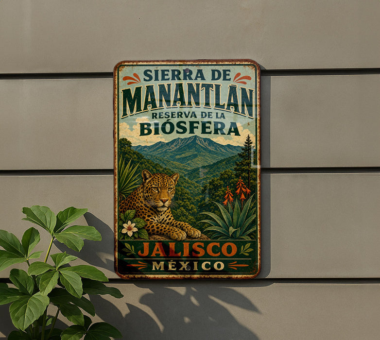 A vintage-style metal sign with a leopard and lush greenery, advertising the Sierra de Manantlan Reserve of the Biosfera in Jalisco, Mexico.