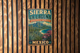 A vintage-style metal sign for Sierra La Laguna Biosphere Reserve in Mexico, featuring a desert landscape with mountains, cacti, and a beach.