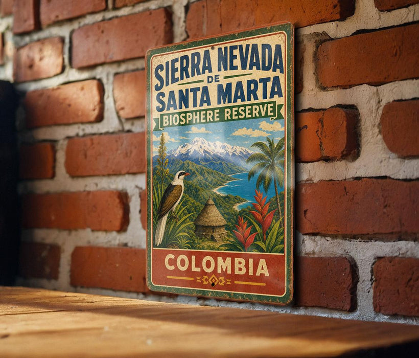 A vintage-style sign for the Sierra Nevada Biosphere Reserve in Colombia, featuring a tropical landscape with a bird and palm trees.