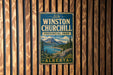 A vintage metal sign for Winston Churchill Provincial Park in Alberta, Canada, featuring a scenic landscape with mountains, a lake, and pine trees.