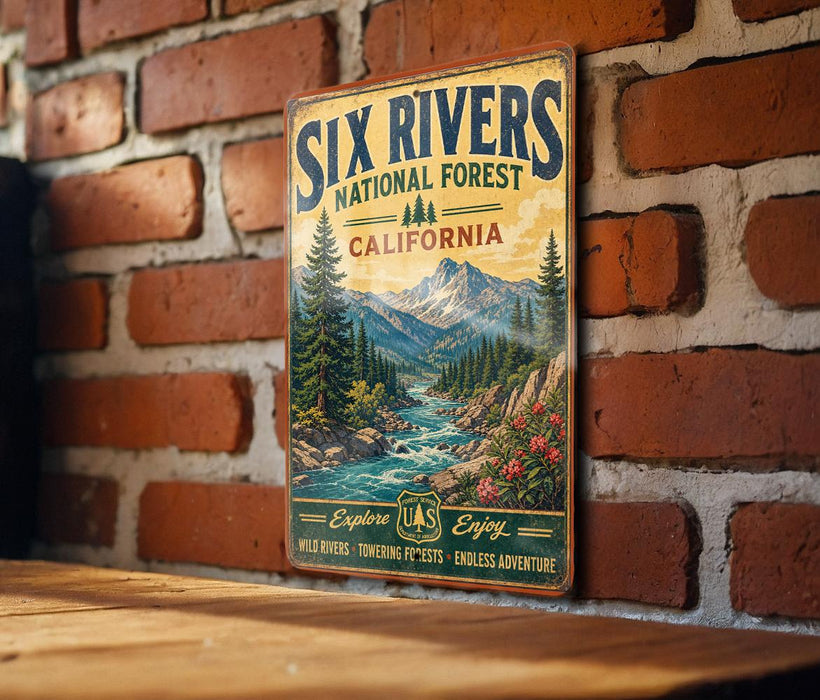 A vintage metal sign for the Six Rivers National Forest in California, featuring a scenic mountain landscape with a river flowing through it.