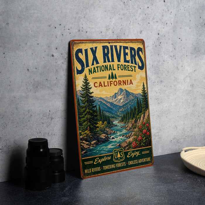 A vintage-style metal sign for the Six Rivers National Forest in California, featuring a scenic illustration of a river surrounded by mountains and pine trees.
