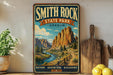 A vintage-style sign for Smith Rock State Park in Oregon, featuring a scenic mountain landscape with a winding river.