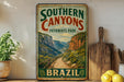 A vintage-style sign for Southern Canyons Pathways Park in Brazil, featuring a scenic illustration of a winding path through a mountainous landscape.