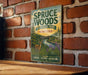 A vintage metal sign for Bruce Woods Provincial Park in Manitoba, featuring a scenic illustration of a deer in a forest setting.