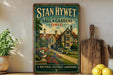 A vintage-style sign for "Stan Hywet Hall & Gardens" in Ohio, featuring a detailed illustration of a historic building surrounded by a well-manicured garden.