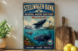 a vintage-style metal sign for Stellwagen Bank National Marine Sanctuary in Massachusetts, with a painting of a whale and other marine life. The sign also includes the words "Explore, Learn, Protect" and "National Marine Sanctuary" in a blue and white color scheme.