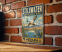 A vintage-style metal sign for Stillwater National Wildlife Refuge in Nevada, featuring a bird illustration and a mountain landscape.
