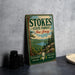 A vintage-style metal sign for Stokes State Forest in New Jersey, featuring a scenic landscape with pine trees, a lake, and mountains.