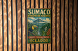a vintage-style sign for Sumaco Biosphere Reserve, which is located in Ecuador. The sign is mounted on a wooden wall and depicts a tropical landscape with a toucan and lush vegetation.