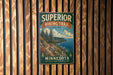 A vintage-style metal sign for the Superior Hiking Trail in Minnesota, featuring a scenic mountain landscape with pine trees and a winding trail.