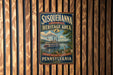 A vintage-style metal sign for Susquehanna National Heritage Area, featuring a steamboat on a river and a scenic landscape.