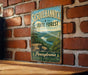 A vintage-style metal sign for Susquehannock State Forest in Pennsylvania, featuring a scenic landscape with a river and mountains.