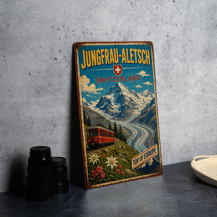 A vintage travel poster advertising Jungfrau-Aletsch, Switzerland, featuring a scenic mountain landscape with a train and flowers.