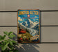 A vintage-style metal sign with a mountain landscape and a red train, mounted on a wall.