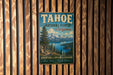 A vintage metal sign for Tahoe National Forest in California, featuring a scenic landscape with mountains, pine trees, and a lake.