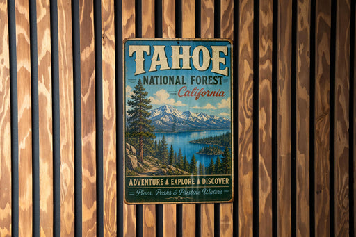 A vintage metal sign for Tahoe National Forest in California, featuring a scenic landscape with mountains, pine trees, and a lake.