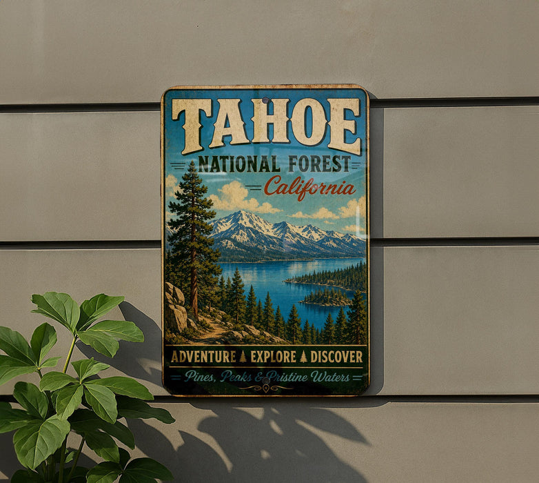 A vintage-style metal sign for Tahoe National Forest, California, featuring a scenic landscape with pine trees, mountains, and a lake.