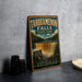 A vintage-style metal sign for Tahquamenon Falls State Park in Michigan, featuring a waterfall and forest scenery.