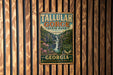 A vintage metal sign for Tallulah Gorge State Park in Georgia, featuring a scenic image of the waterfall and surrounding landscape.