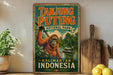 A vintage-style sign for Tanjung Puting National Park in Kalimantan, Indonesia, featuring an illustration of an orangutan in a lush, green forest setting.