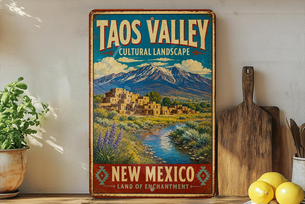 A vintage-style sign for the Taos Valley Cultural Landscape in New Mexico, featuring a scenic landscape with mountains, adobe buildings, and a river.