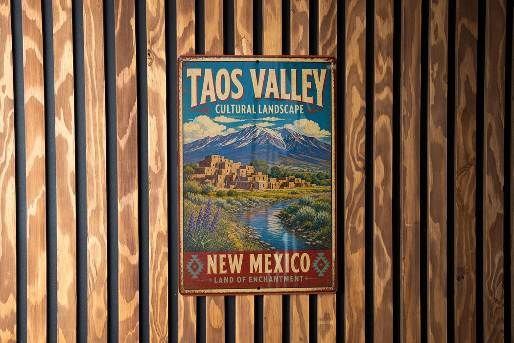 A vintage-style metal sign for the Taos Valley in New Mexico, featuring a mountain landscape and a small town.