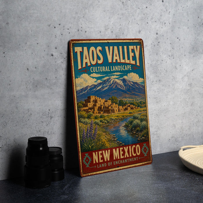 A vintage-style sign for the Taos Valley Cultural Landscape in New Mexico, featuring a scenic illustration of the area with mountains, buildings, and a river.