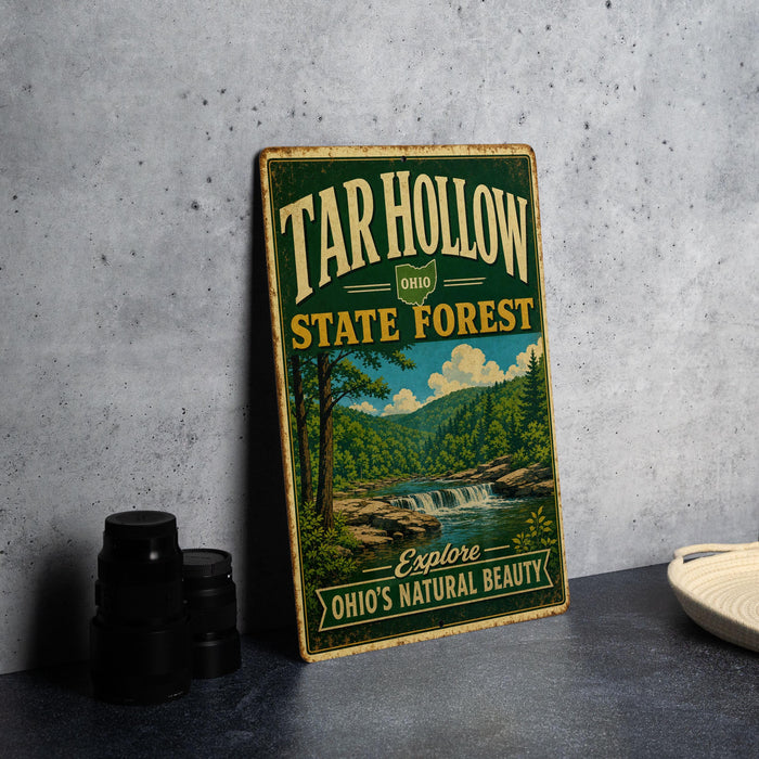 A vintage-style sign for the Tar Hollow State Forest in Ohio, featuring a scenic landscape with a waterfall and forest.
