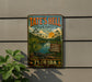 A vintage-style metal sign for Tate's Hell State Forest in Florida, featuring a tropical landscape with palm trees, a lake, and an alligator.