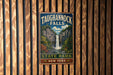 A vintage metal sign for Taughannock Falls State Park in New York, featuring a waterfall and lush greenery.