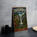 A vintage-style metal sign for Taughannock Falls State Park in New York, featuring a waterfall and lush greenery.