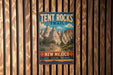A vintage metal sign for the Tent Rocks Trail in New Mexico, featuring a scenic illustration of the rock formations and a message encouraging hikers to explore and discover the trail.
