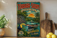 A vintage-style metal sign advertising a tour to the terrabana region in Costa Rica, featuring a colorful illustration of a tropical landscape with a boat, palm trees, and a toucan.