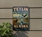 A vintage-style metal sign for Teltlin National Wildlife Refuge in Alaska, featuring wildlife such as a moose, eagle, and loon.