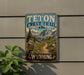 A vintage-style metal sign for the Teton Crest Trail in Wyoming, featuring a scenic mountain landscape and trail marker.