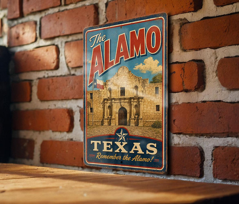 A vintage-style metal sign with the text "The Alamo" and "Texas Remember the Alamo!" displayed on a brick wall.