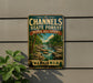 a vintage-style metal sign with a scenic landscape of a river and forest, mounted on a wall.