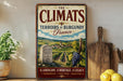 A vintage-style sign advertising "The Climats" wine from Burgundy, France, featuring a landscape with vineyards and a gravestone.